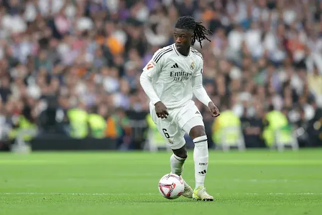 Eduardo Camavinga dribbling the ball in Real Madrid's white kit during a match.