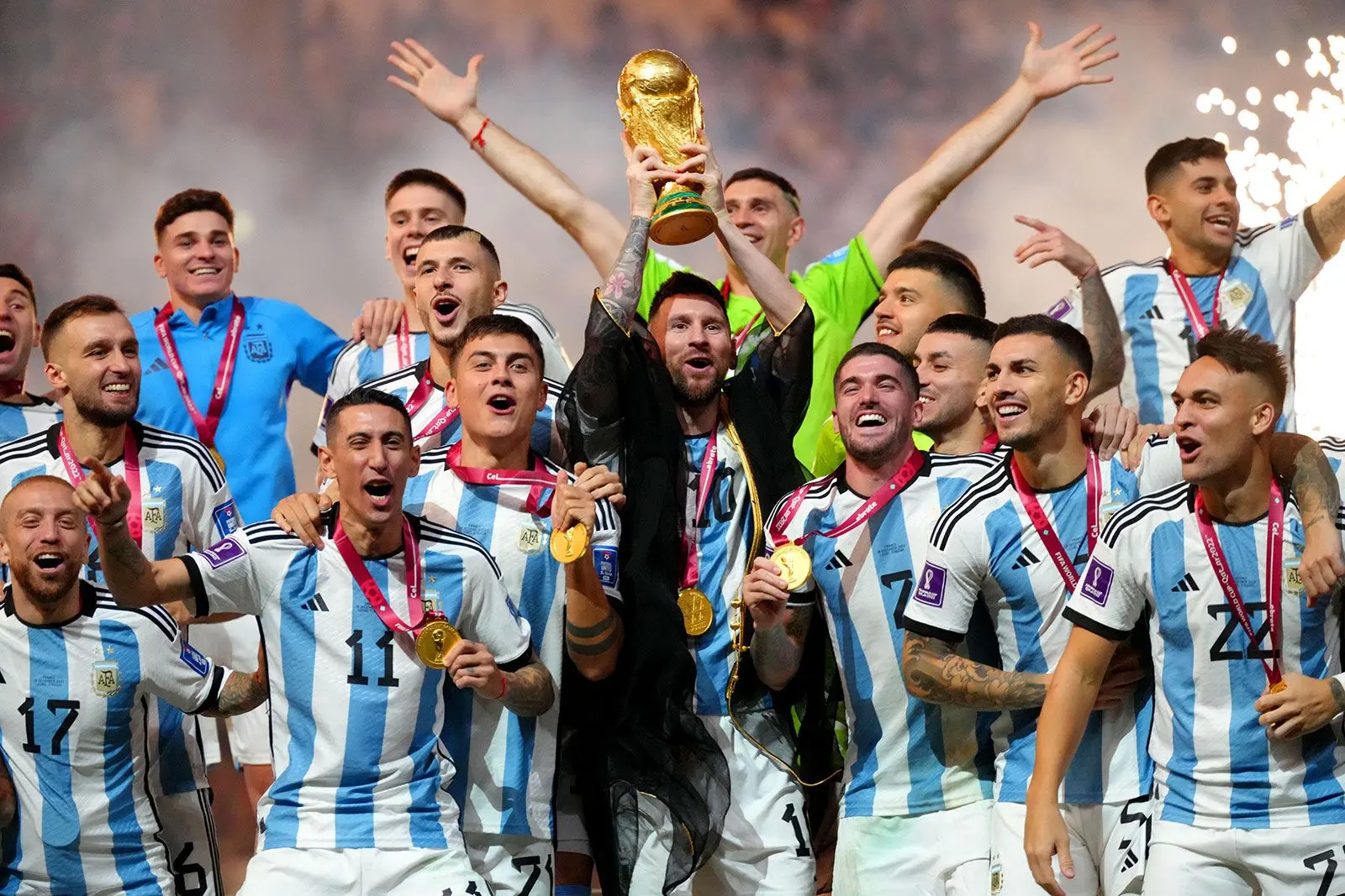 Lionel Messi and the Argentina national team celebrating with the FIFA World Cup trophy