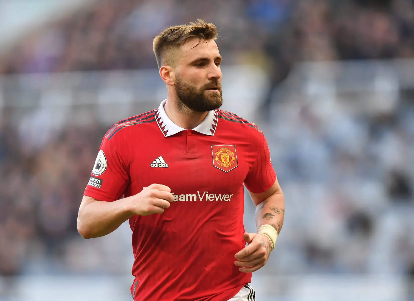 Luke Shaw wearing Manchester United's red home jersey during a match.