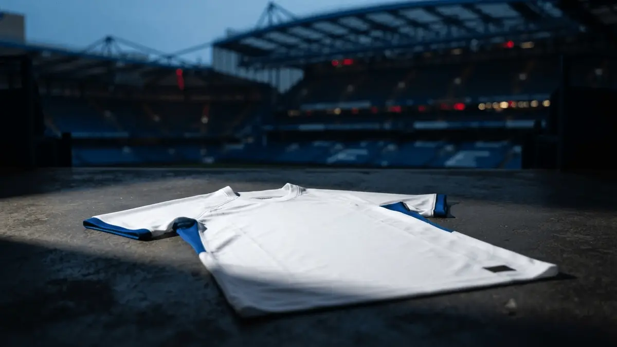 Chelsea Women's jersey with Stamford Bridge stadium in background representing Malard transfer