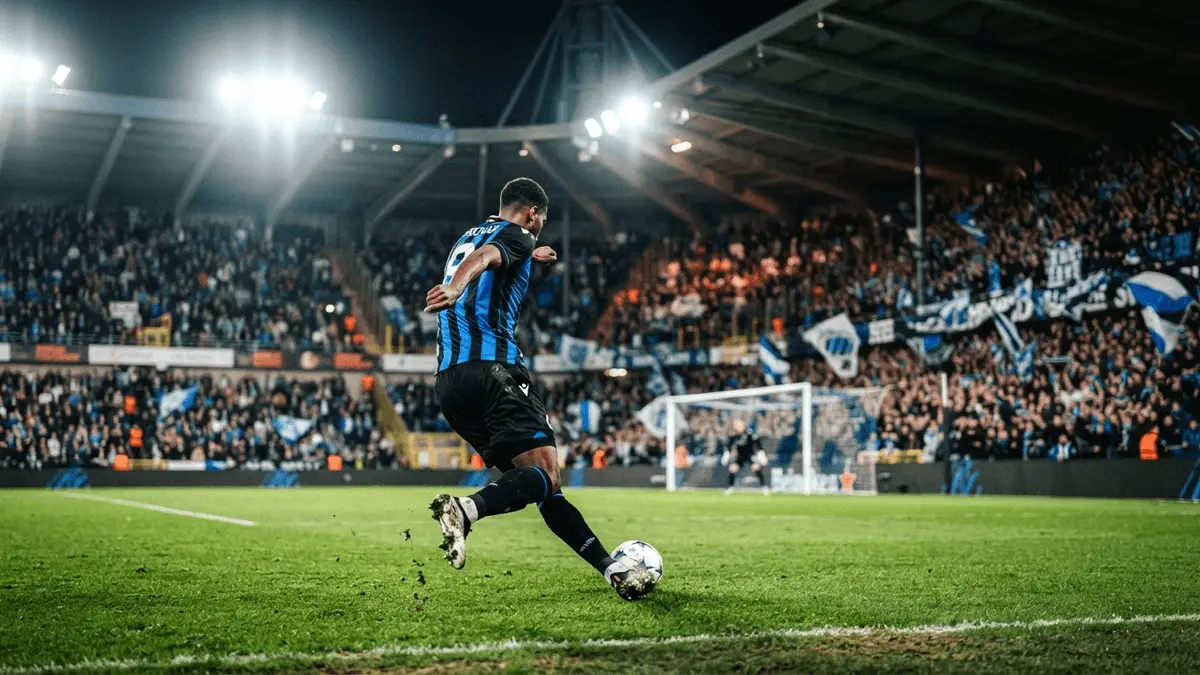 Football striker in action at a European stadium under floodlights