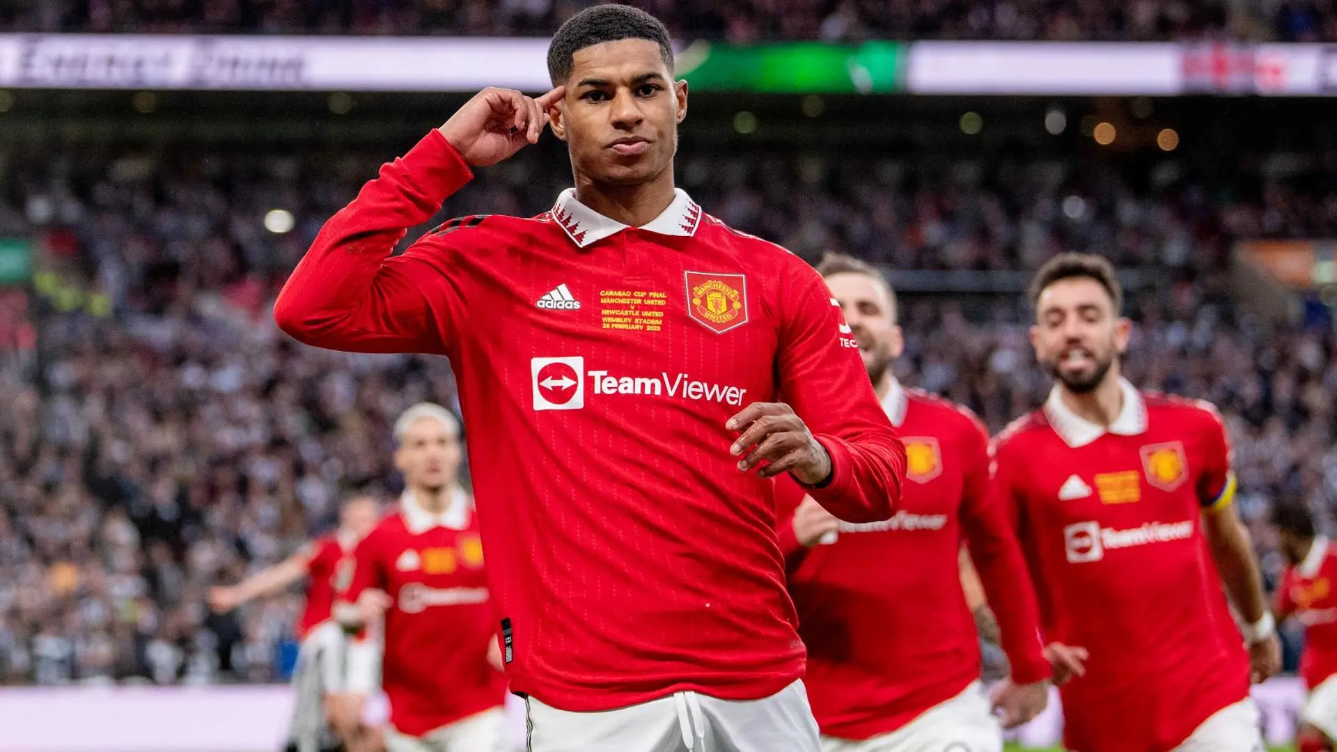 Marcus Rashford celebrating after scoring for Manchester United in a match.