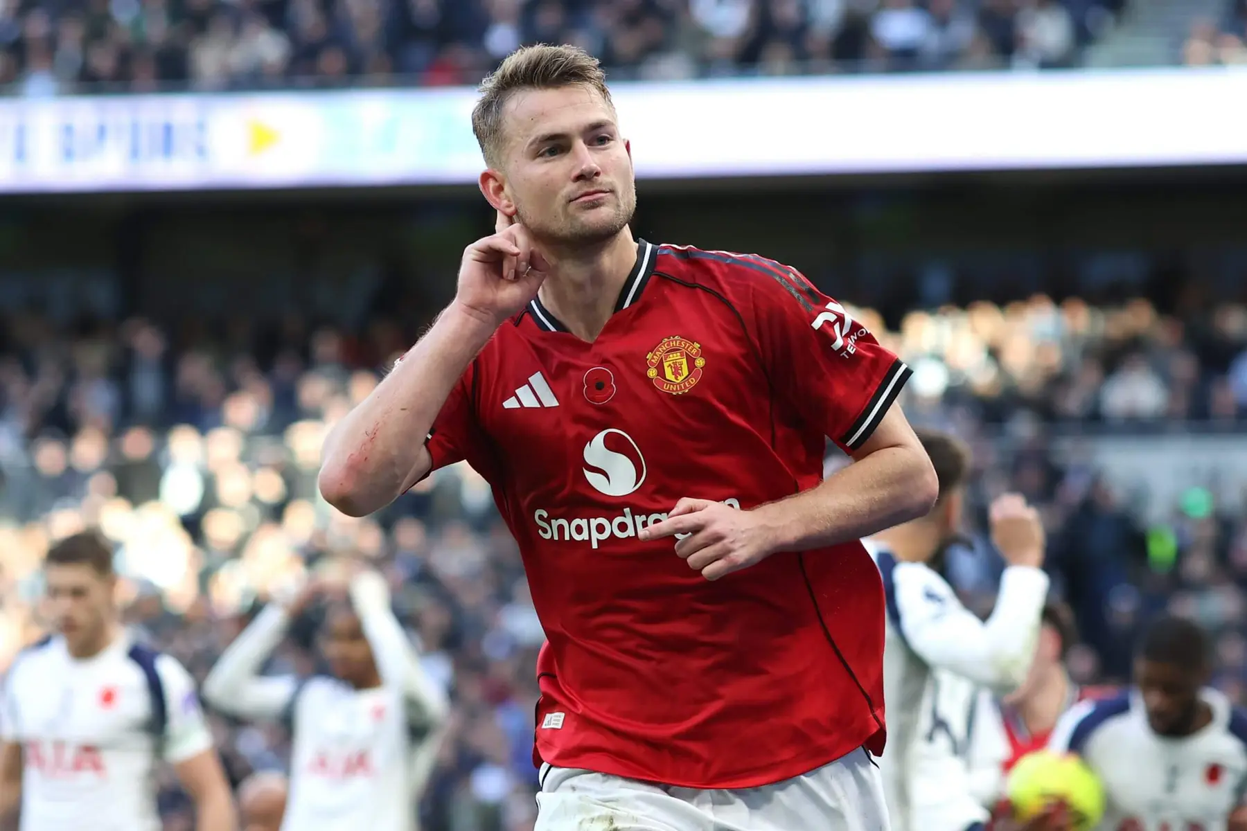 Matthijs de Ligt in a red Manchester United kit celebrating on the pitch