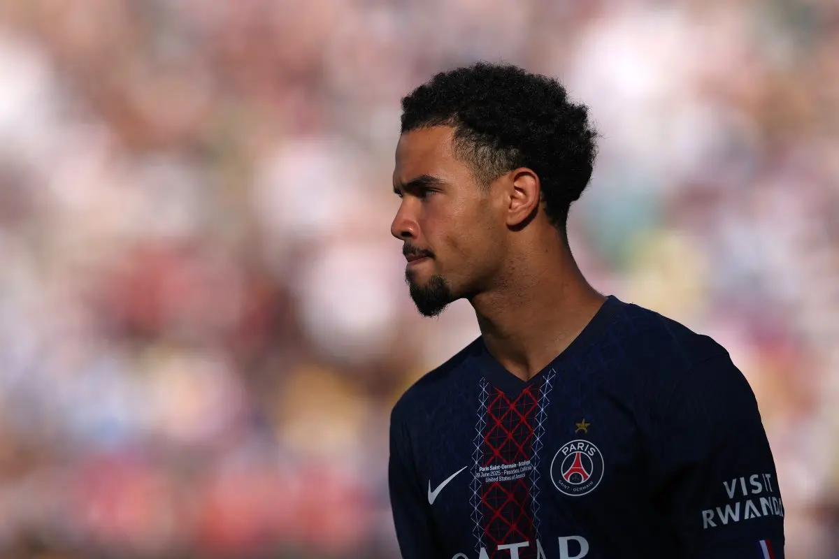 Warren Zaire-Emery in PSG jersey during a match, focused and serious expression.