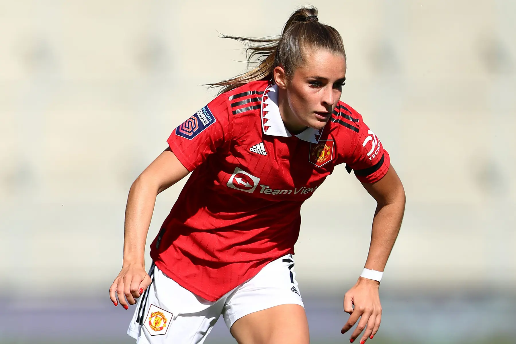 Ella Toone in a red Manchester United Women's kit during a football match