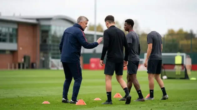 Former centre-back coach gives two young defenders individual training at a football ground