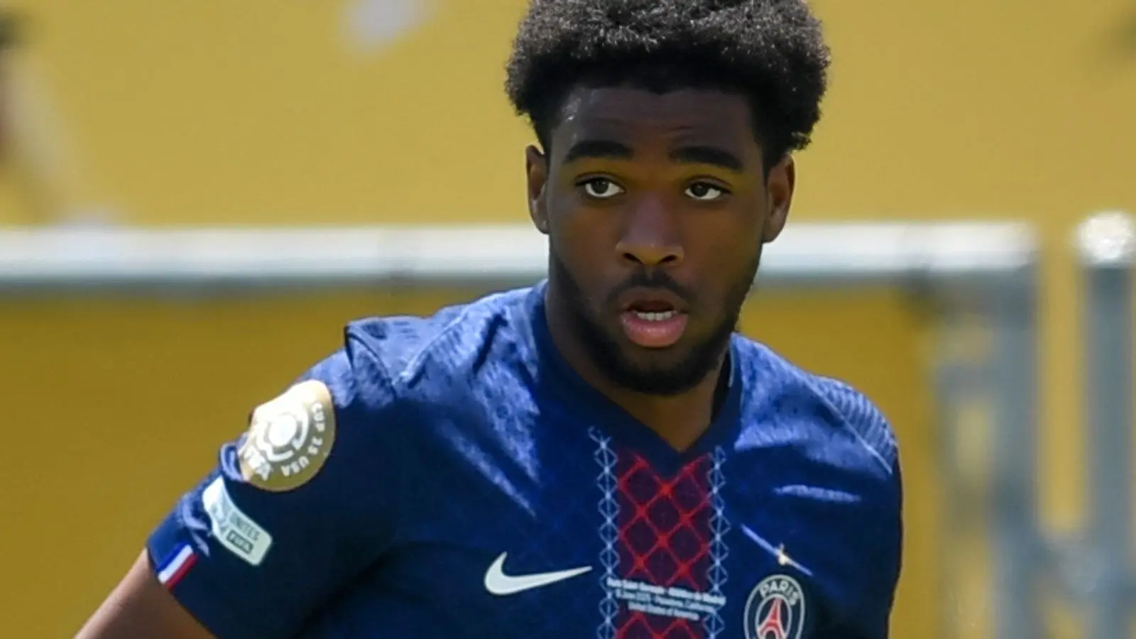 Ibrahim Mbaye wearing a blue Paris Saint-Germain jersey during a match
