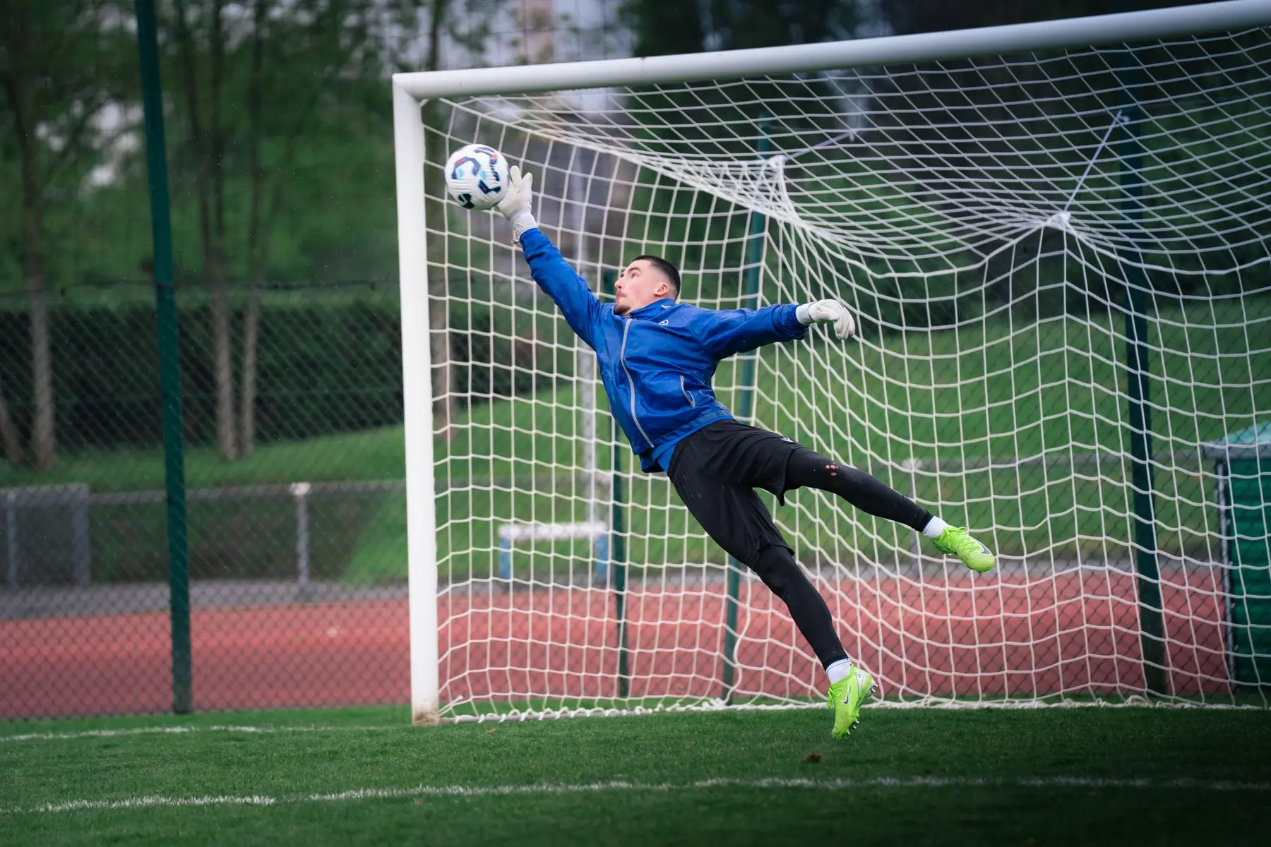 Goalkeeper Louis Page diving to make a save during a Leicester City training session