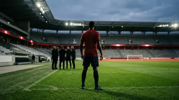 Striker in a red-and-blue kit facing open space in a stadium, symbolising Mateta’s conditional Manchester United transfer