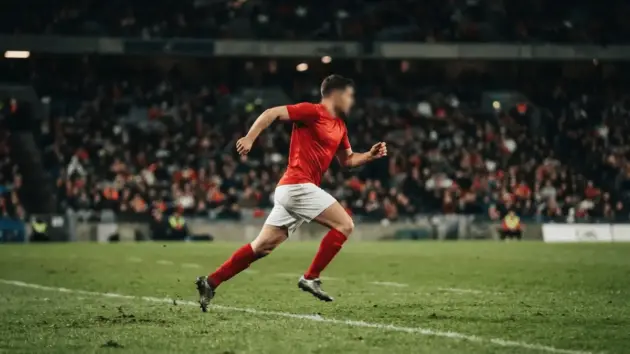 Manchester United-inspired forward creating an assist during a floodlit pre-season football match