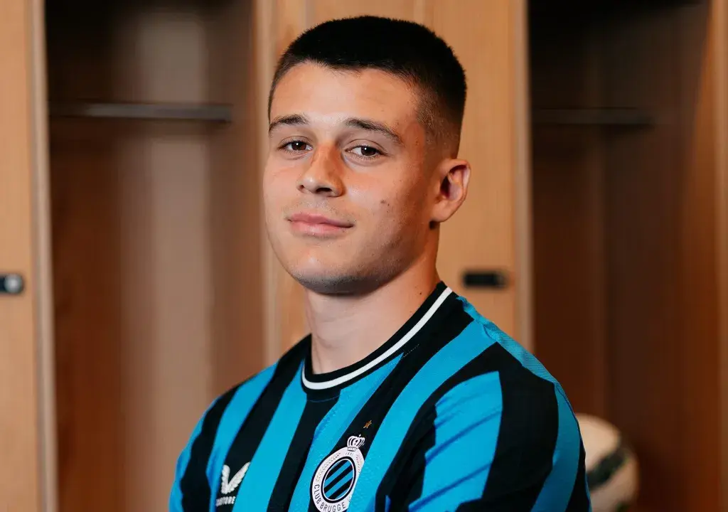 Portrait of Nicolo Tresoldi wearing a blue and black striped Club Brugge jersey