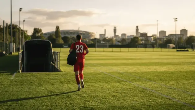 Manchester United player returning to training ground at sunset in Dublin