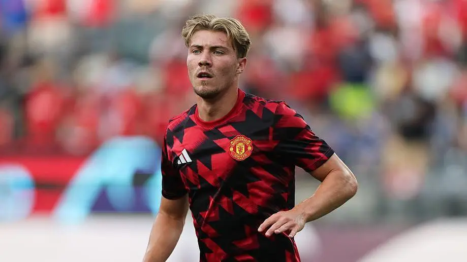 Rasmus Hojlund wearing a red and black Manchester United training kit on a football pitch