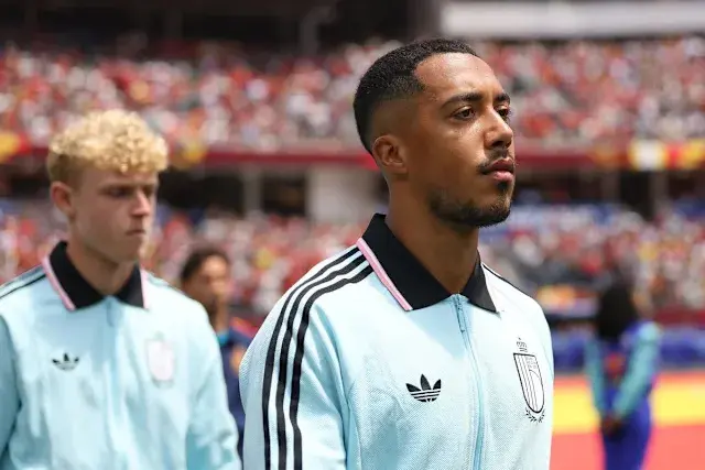 Youri Tielemans wearing a light blue Belgium national team training jacket during a match lineup