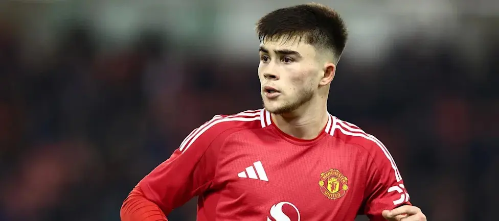 Harry Amass wearing a red Manchester United home jersey during a match