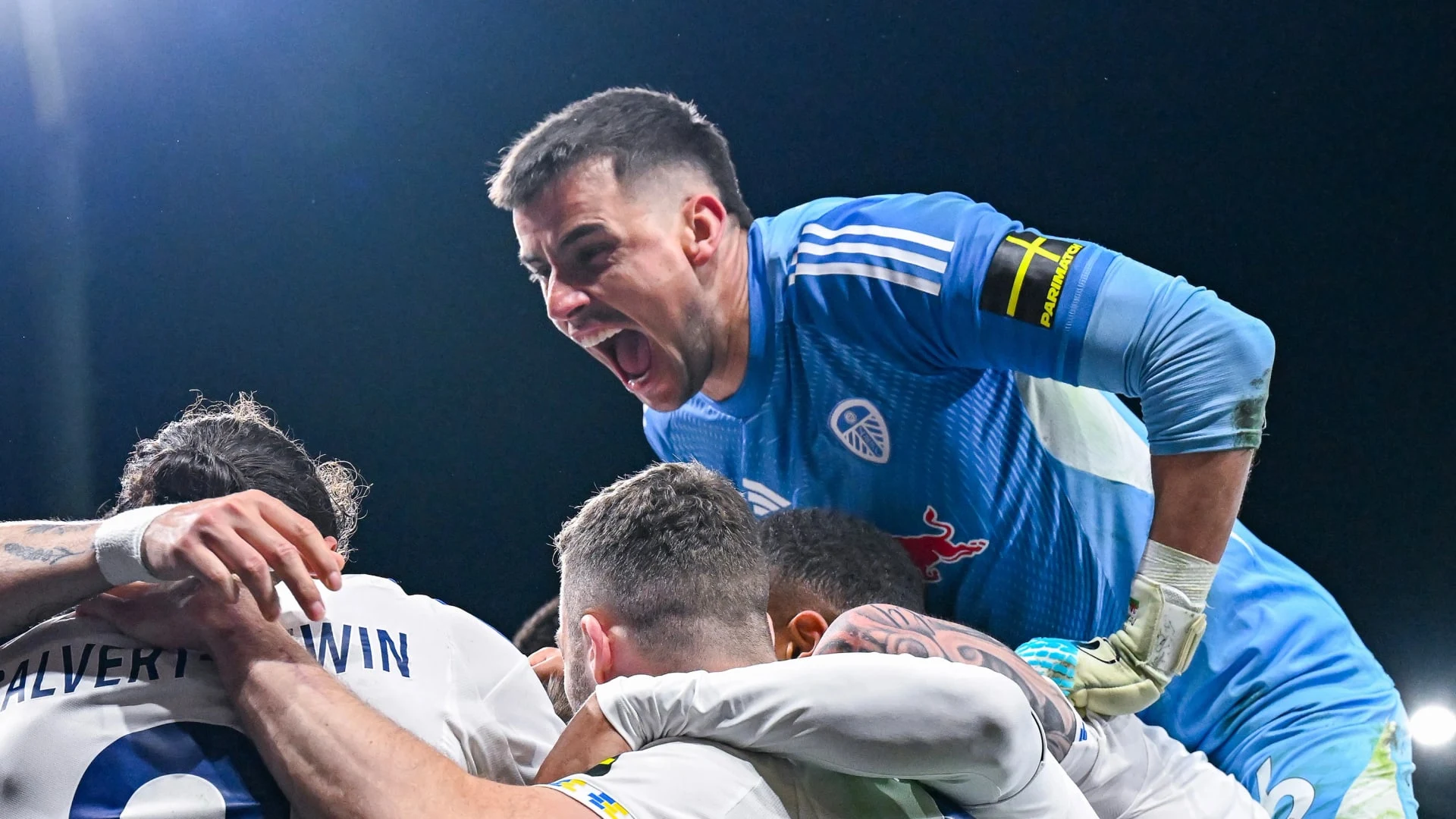 Karl Darlow shouting in celebration while embracing teammates during a match.