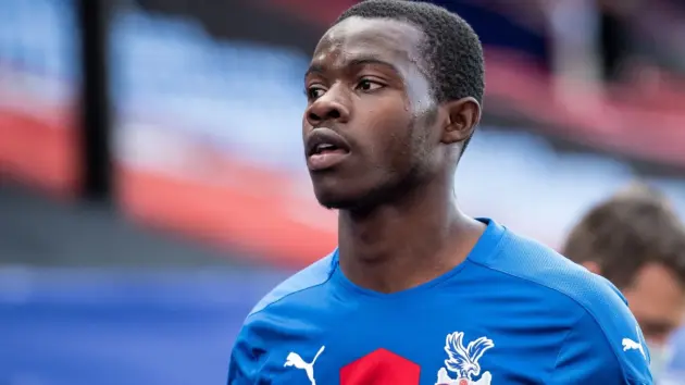 Close-up of Tyrick Mitchell wearing a blue Crystal Palace jersey.