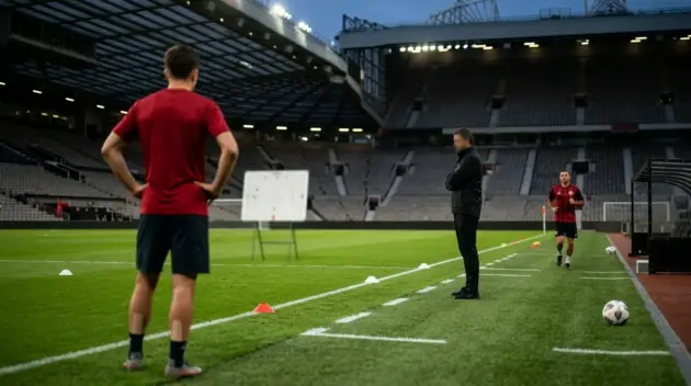 Anonymous football defender assessed before a Manchester derby in a floodlit stadium
