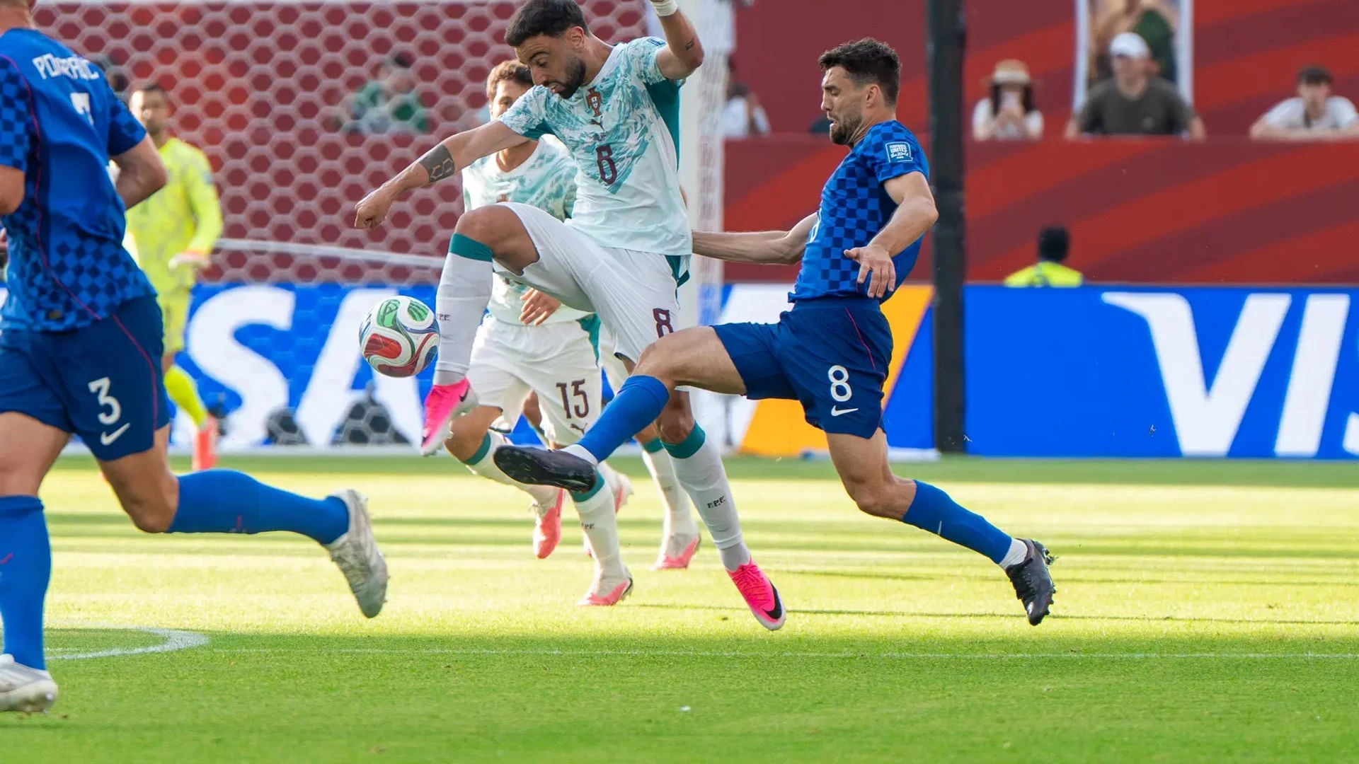 Bruno Fernandes of Portugal competes for the ball against Mateo Kovacic of Croatia during a match.