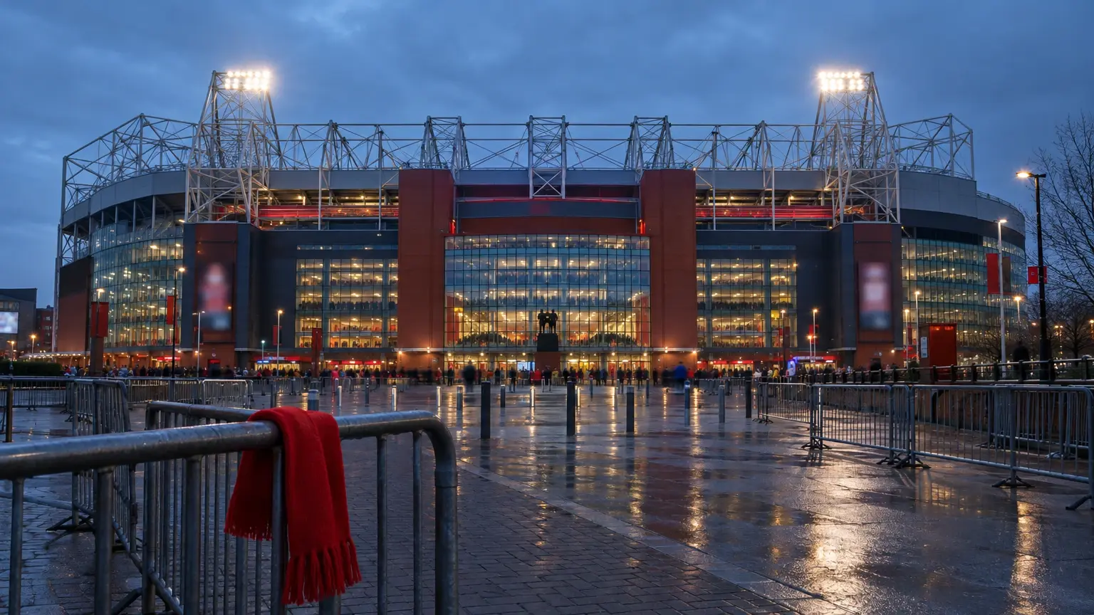 Old Trafford exterior illuminated on a winter evening for Manchester United’s December fixture schedule